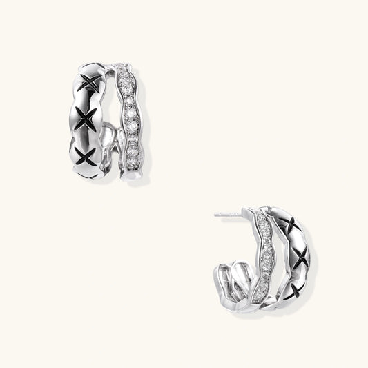 Triple-row white gold hoops with black X-pattern, twisted band, and pavé zirconia stones on white background.