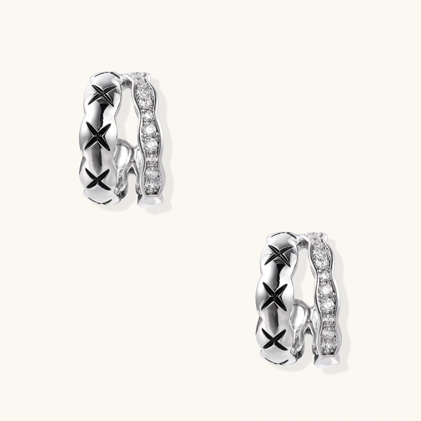 Triple-row white gold hoops with black X-pattern, twisted band, and pavé zirconia stones on white background.
