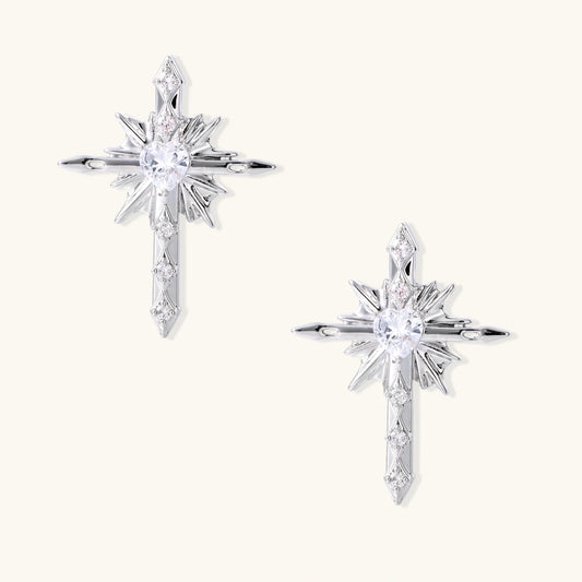 Silver starburst earrings with radiating points and dagger drop design featuring clear zirconia stones